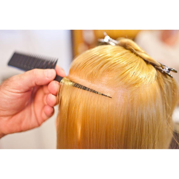 Person demonstrating step #1 in using the Highlighting and foiling comb to easily color hair 